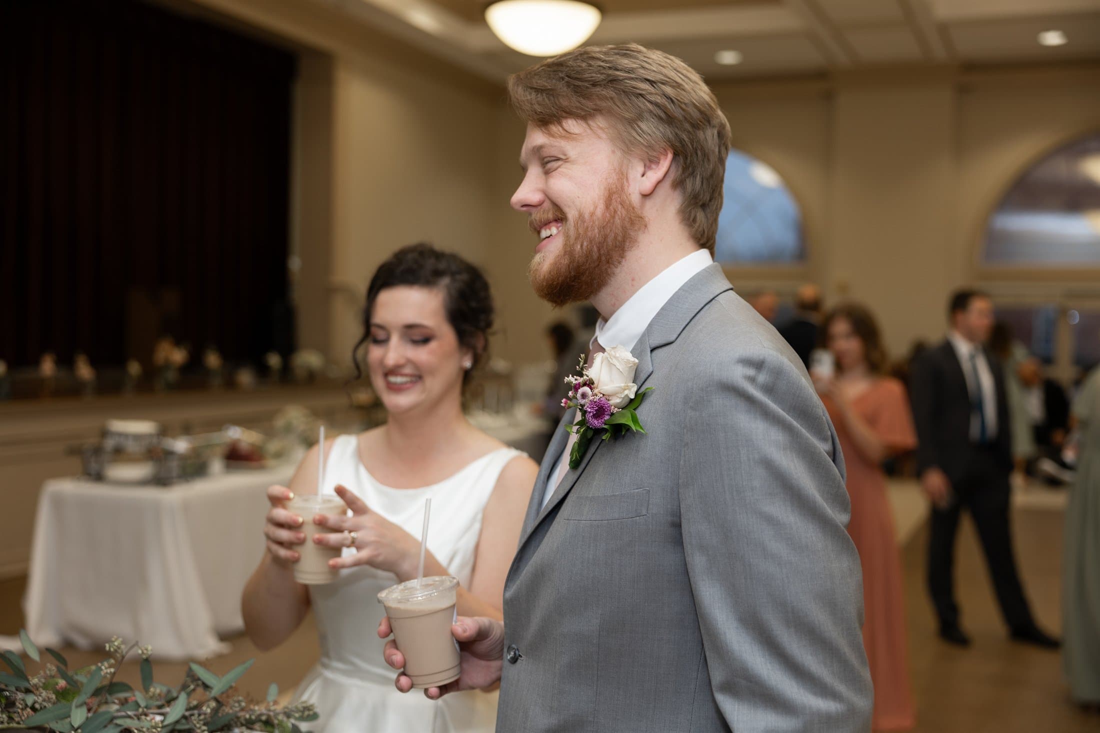Married couple holding coffee cart drinks